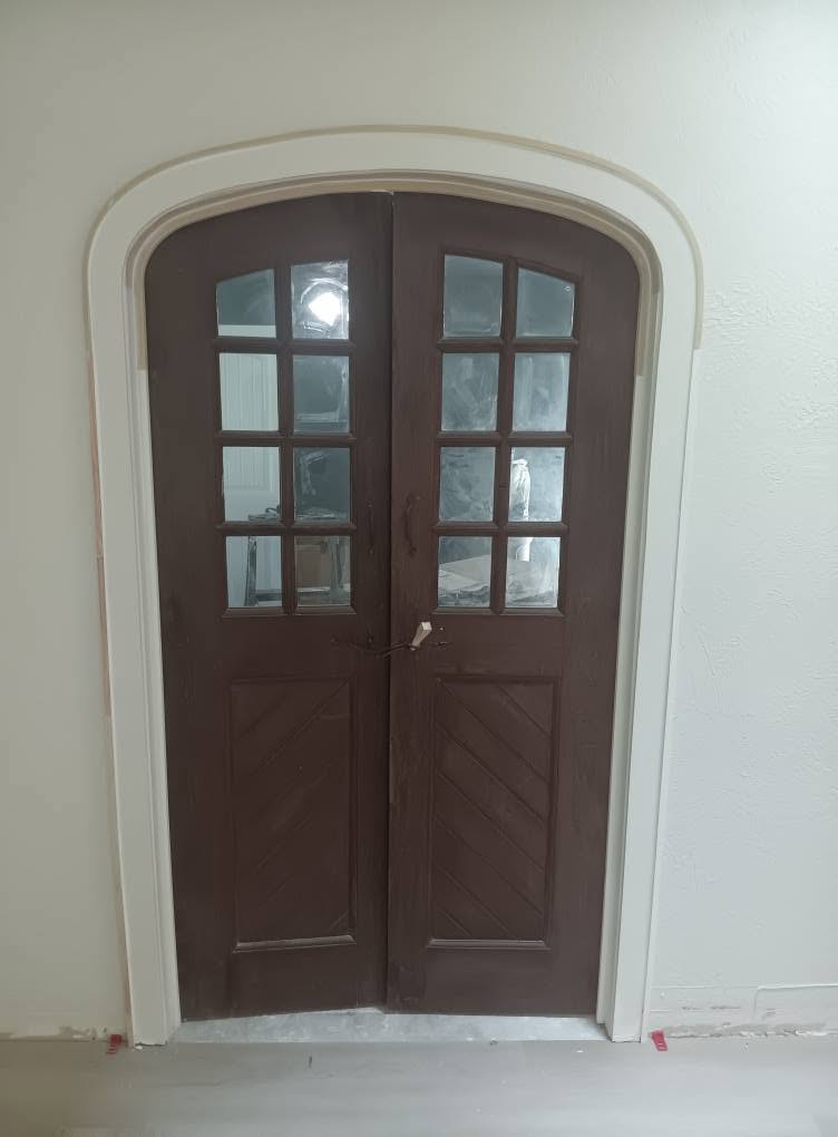 Arched wood doors and detailed white trim from Premier’s original work collection
